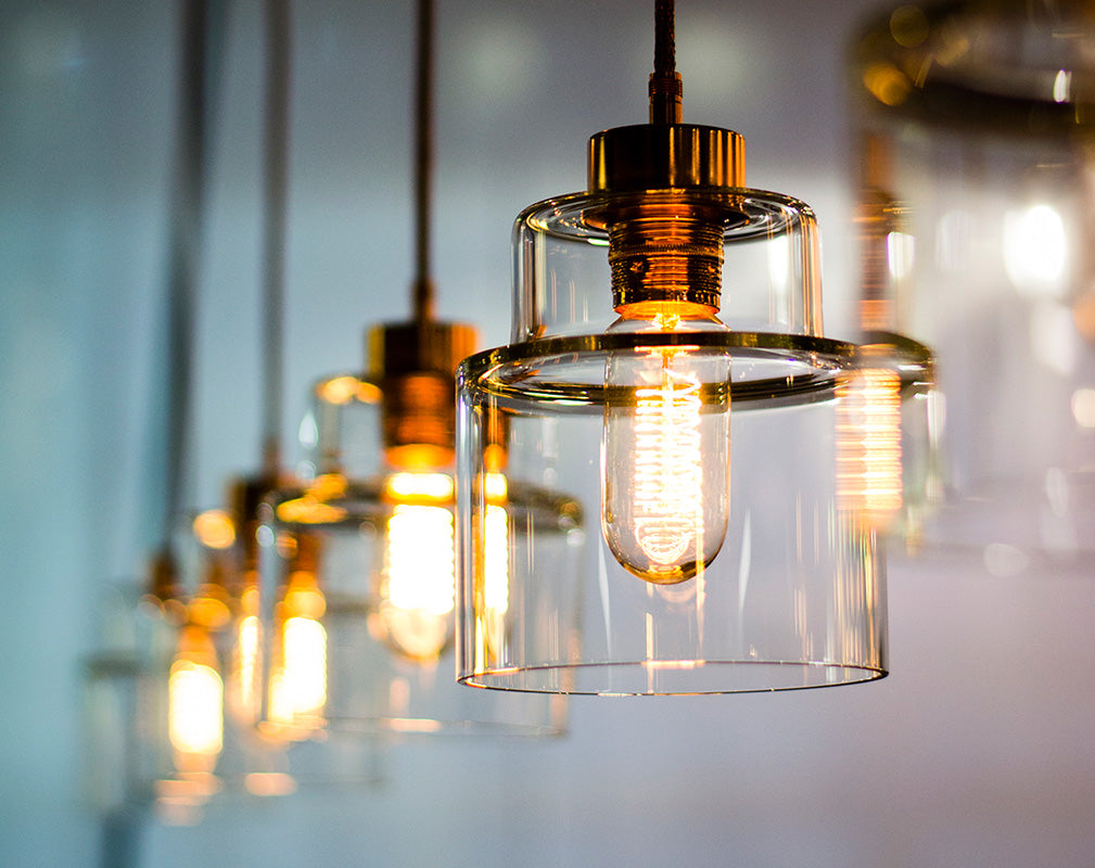 Factory style pendants in clear handblown glass and bronze detail from rothschild & bickers