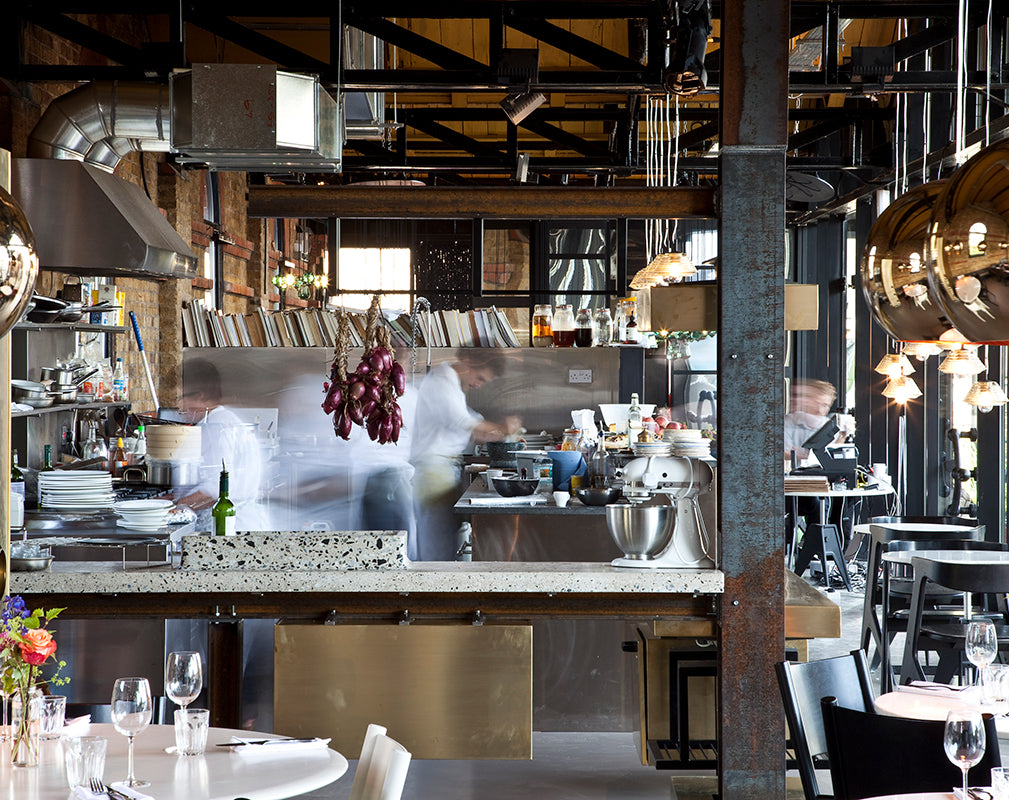 rusted steel columns feature in this restaurant interior designed by tom dixon
