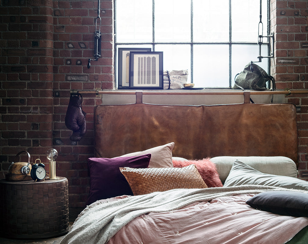 bedroom in warehouse conversion featuring vintage gym furniture and accessories