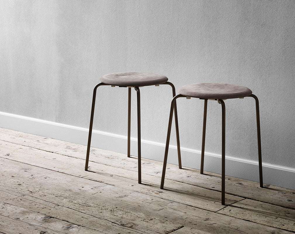 lightweight and stackable stool with leather by Arne Jaconbsen for Fritz Hansen.