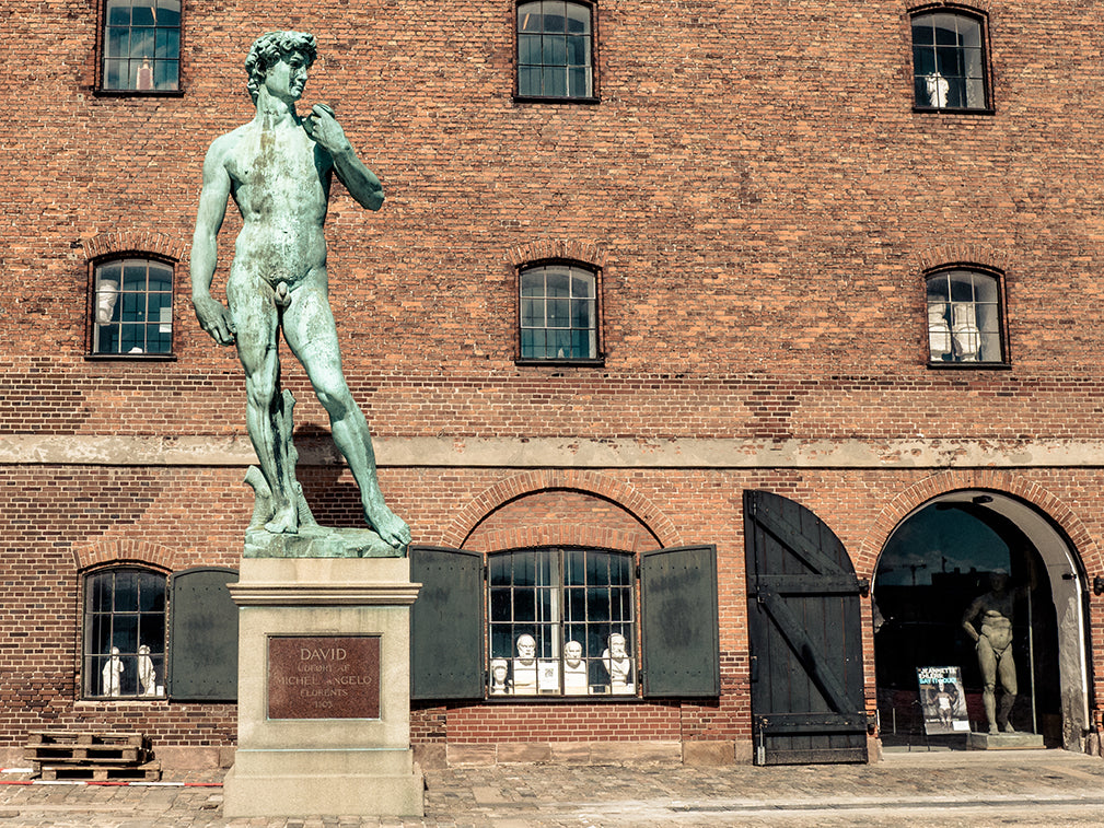 exterior of the west indian warehouse, copenhagen featuring sculptures from the royal cast collection