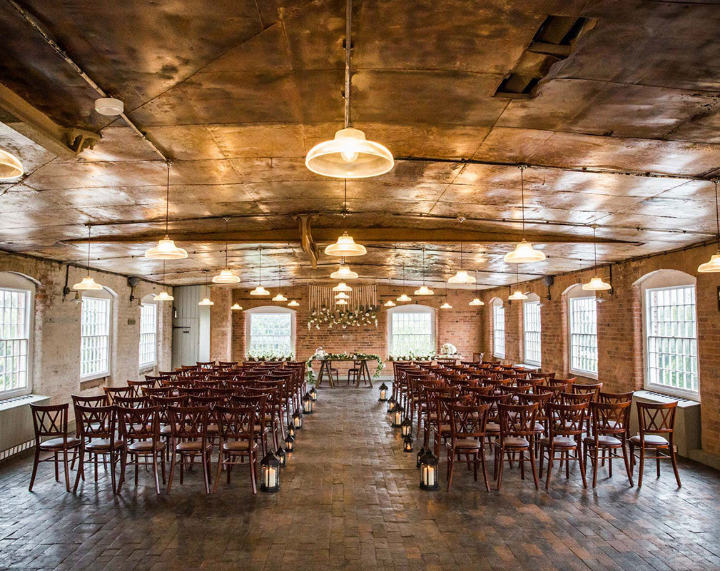 Impressive warehouse wedding venue styled by Artifact Lighting.