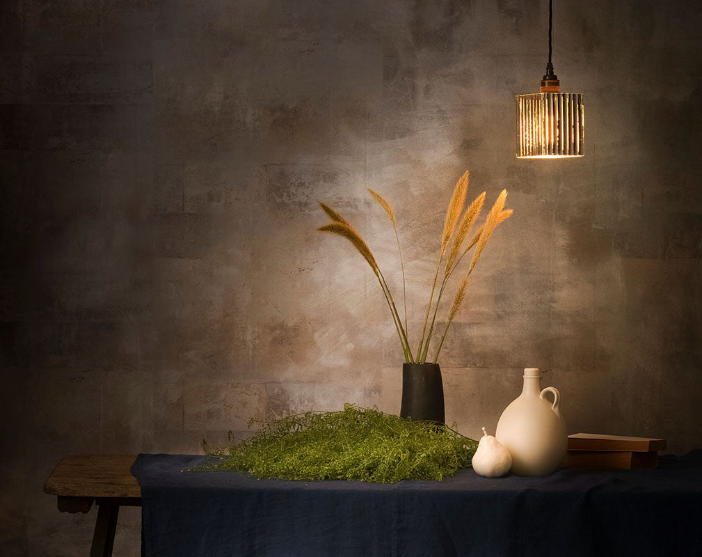 reeded glass pendant from the light yard suspended over stylish dining table.