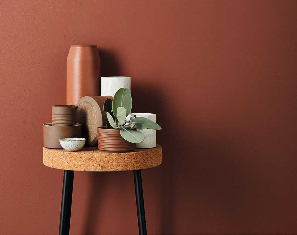 Assorted marble and terracotta vessels on cork stool by Lightly.