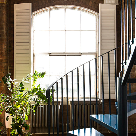 London warehouse conversion with warehouse windows and a steel spiral staircase