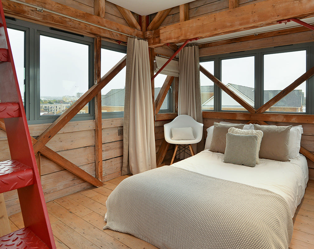 bedroom with view of river thames inside this converted london warehouse apartment