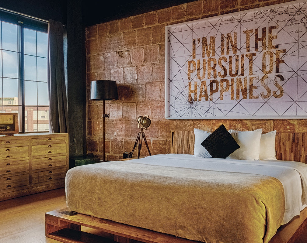 vintage interior scheme with exposed brick and reclaimed timber headboard