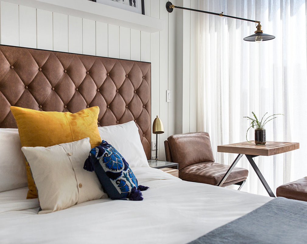 guest bedroom at the williamsburg hotel brooklyn new york features buttoned leather upholstery