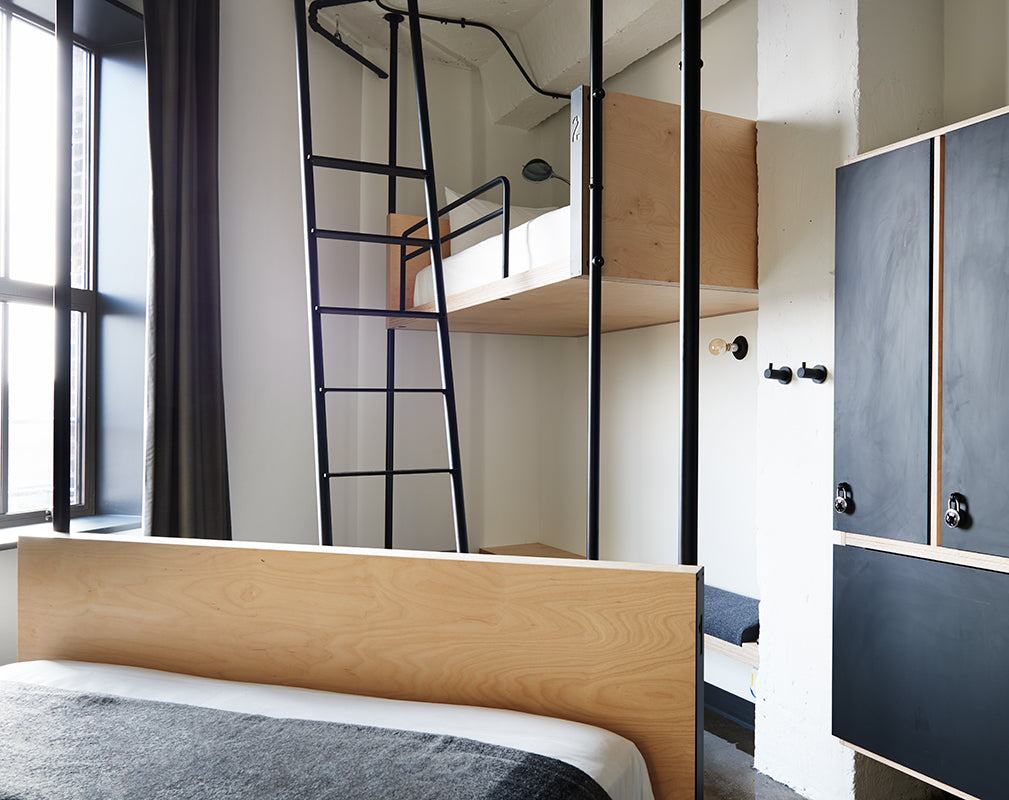 interior bedroom of the hollander hostel chicago with plywood and black metal finishes
