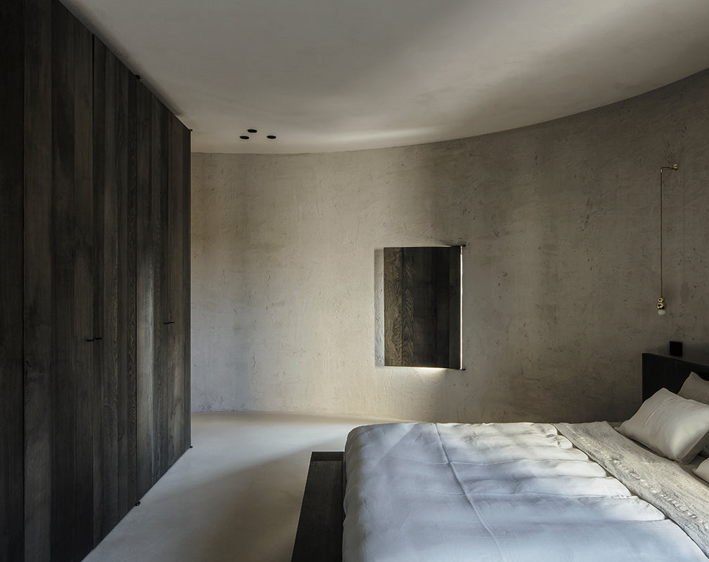 minimalist bedroom scheme inside a converted silo apartment in kanaal antwerp