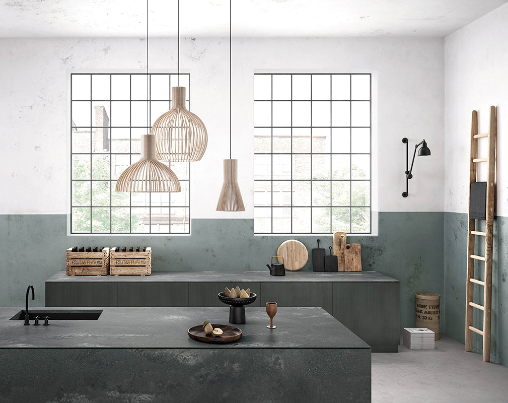 urban industrial kitchen with sage green walls and concrete effect quartz worktops from caeserstone