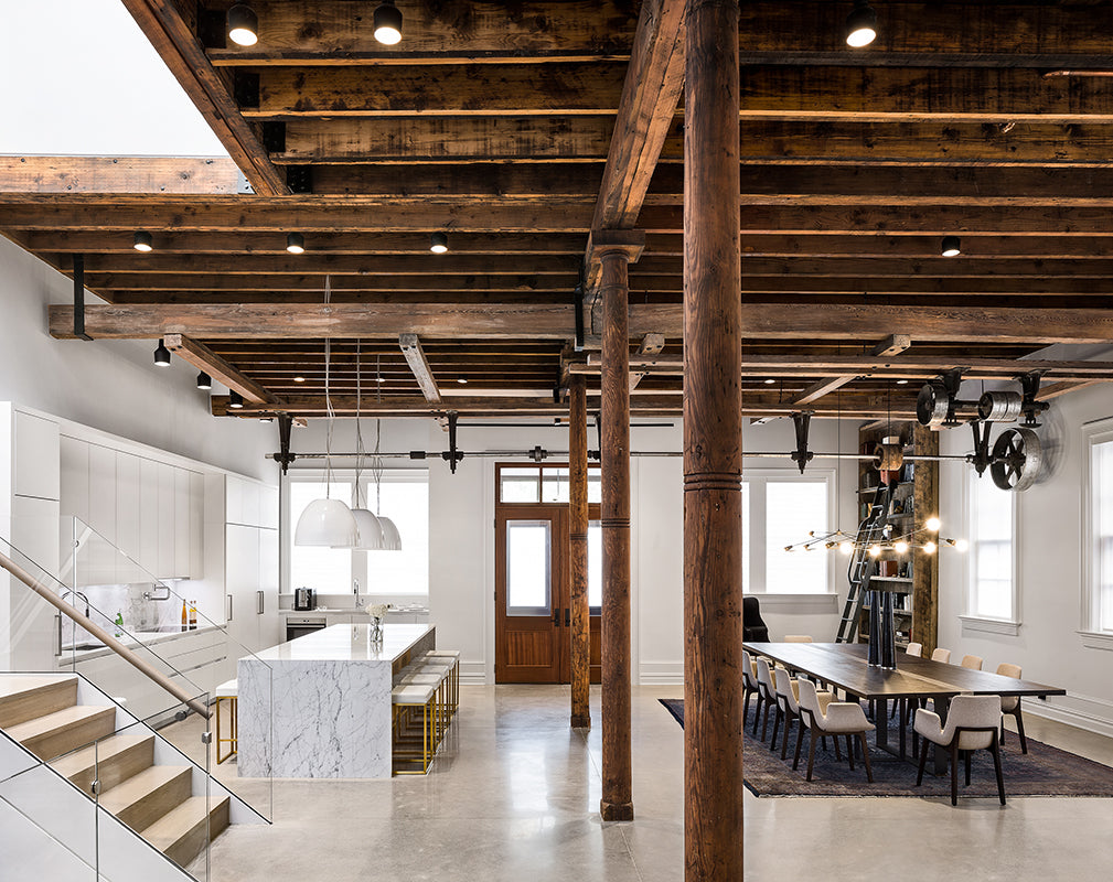 open plan living room in this new jersey warehouse conversion features exposed wooden beams and columns