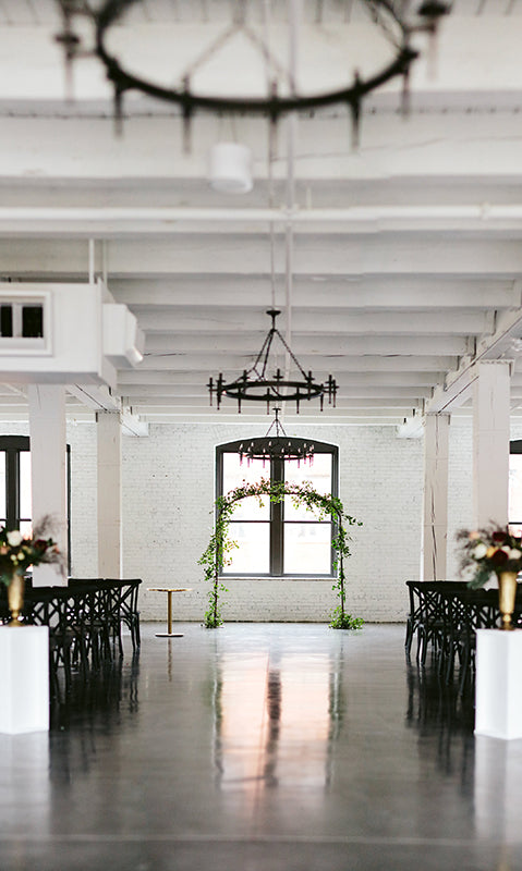 white painted brick walls and exposed wooden beams feature in this warehouse wedding venue