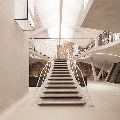 Sculptural concrete staircase features in this contemporary loft conversion in salzburg, austria