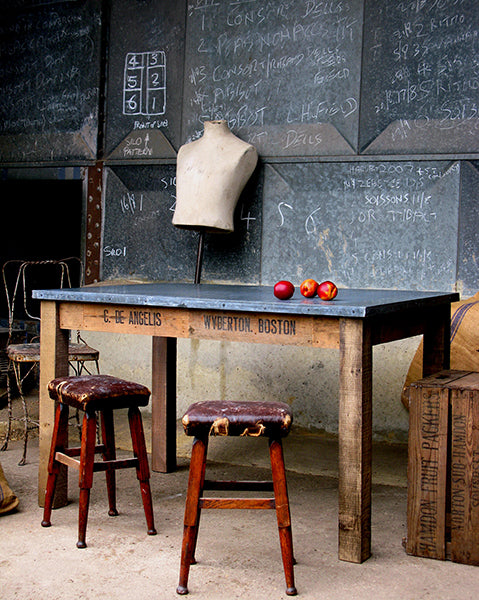 zinc topped workstation with red stools and vintage mannequin from quirky interiors