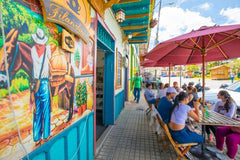 Colombian cafe with people eating and drinking outside