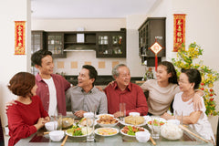 Chinese family sitting around chinese new year table feast