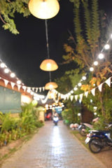 Colombian outdoor cafe with lights and greenery