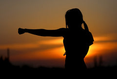 Shadow of a woman working out