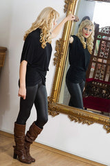 woman with a healthy body image looking in a mirror