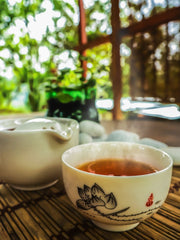 tea and teapot sitting side by side in spring outdoor place