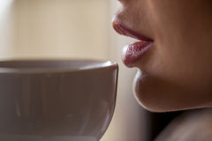 Woman drinking tea to help her teeth