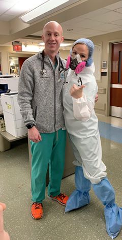 Two healthcare workers in scrubs