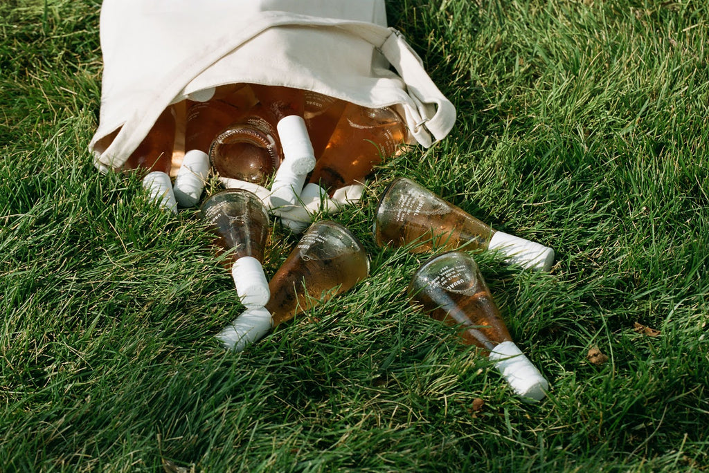 Bottles of Usual Wines rose on the grass