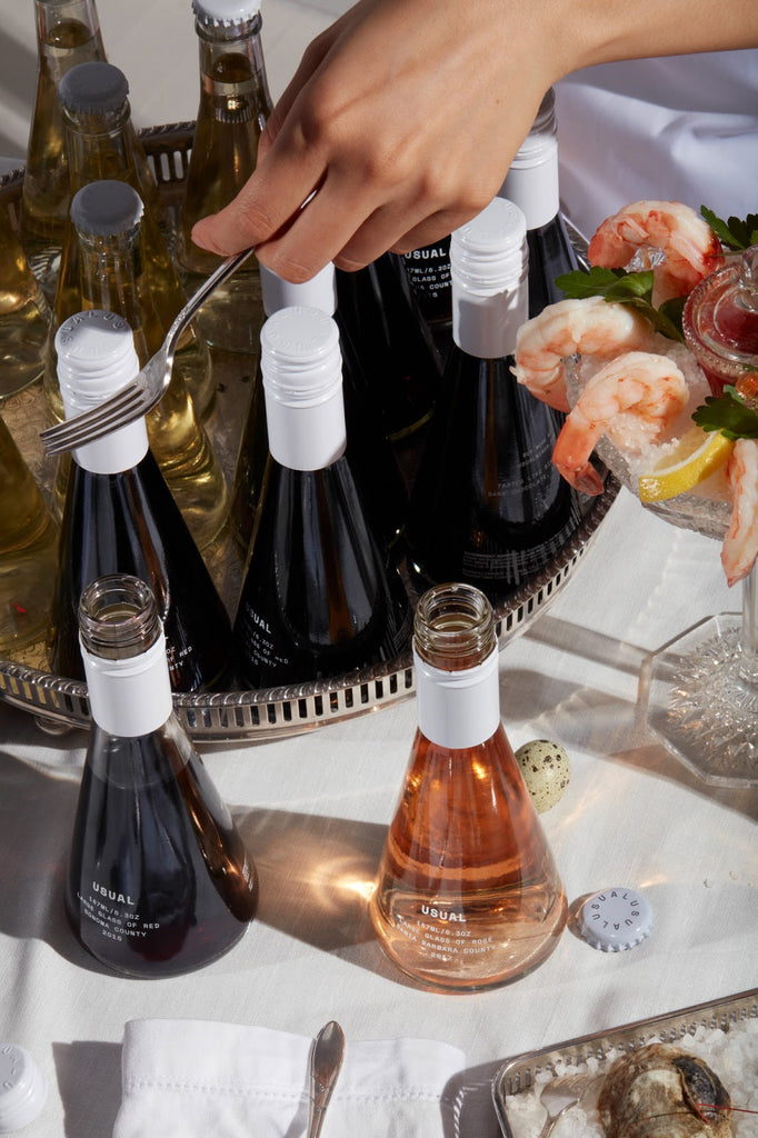 Wine legs: A table spread with Usual Wines and shrimp cocktail