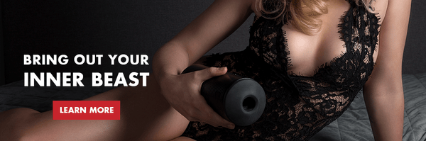 titan by kiiroo held in a woman's hand on bed