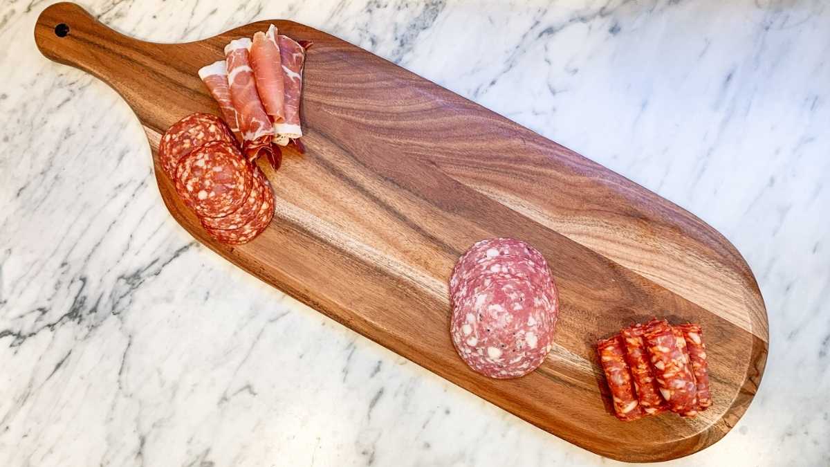 >
<p><strong>3. Don’t Forget The Cheese</strong></p>
<p>Once you have got a variety of cured meats on your platter, you will need to pick up a few different types of cheese. </p>
<p>This will add more flavour and texture to your charcuterie board and will boost its appeal. Aim to include a variety of soft and hard cheeses - some popular options include gouda, cheddar, brie, and camembert. </p>
<p>Just remember not to go overboard with the cheese - this is a charcuterie board, after all. </p>
<img src=