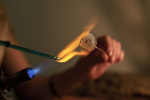 Molten glass on a steel rod is called flameworking