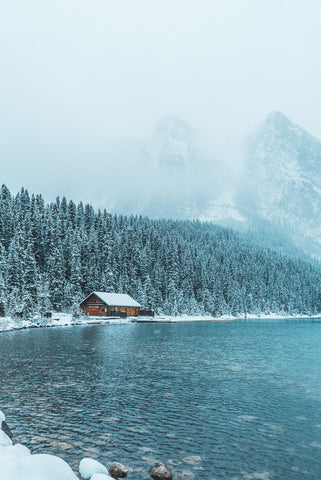 Small house on a lake in deep winter