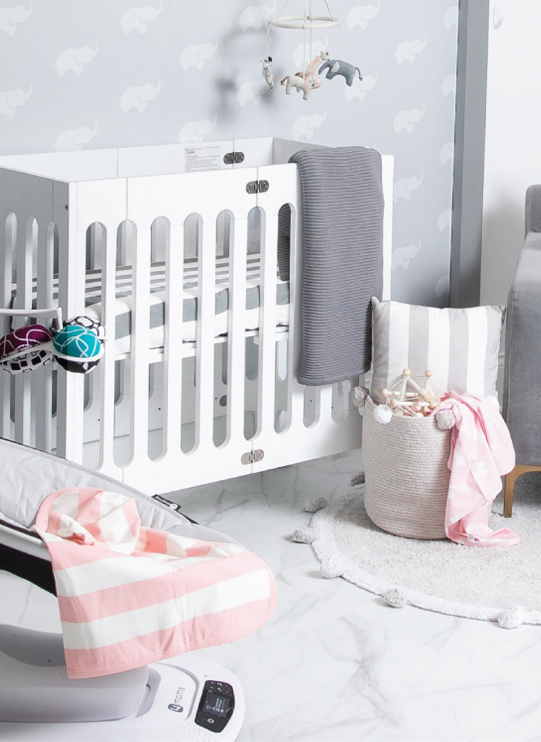 Nursery with crib, blanket, and accessories.