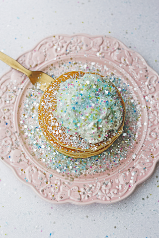 Unicorn Pancakes with Bakery Bling Edible Glitter Unicorn Confetti Blinged-Out Glittery Sugar Sprinkles on a Pastel Pink Elegant Ornate Plate.