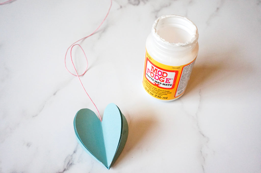 Make a heart-themed mobile from leftover children's wallpaper