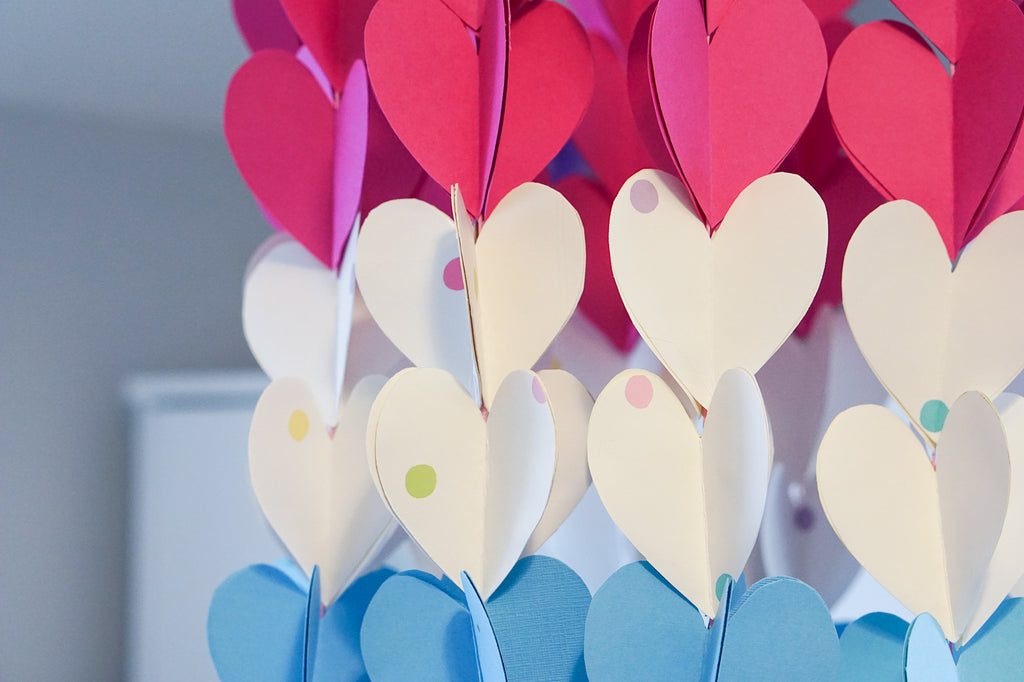 Make a heart-themed mobile from leftover children's wallpaper