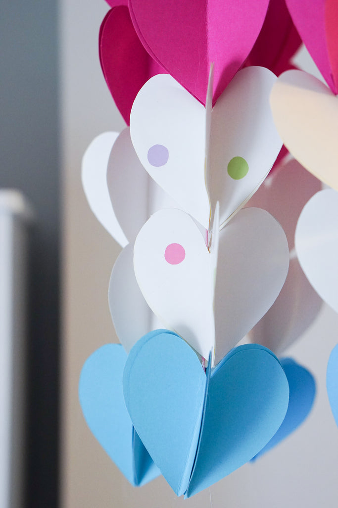 Make a heart-themed mobile from leftover children's wallpaper