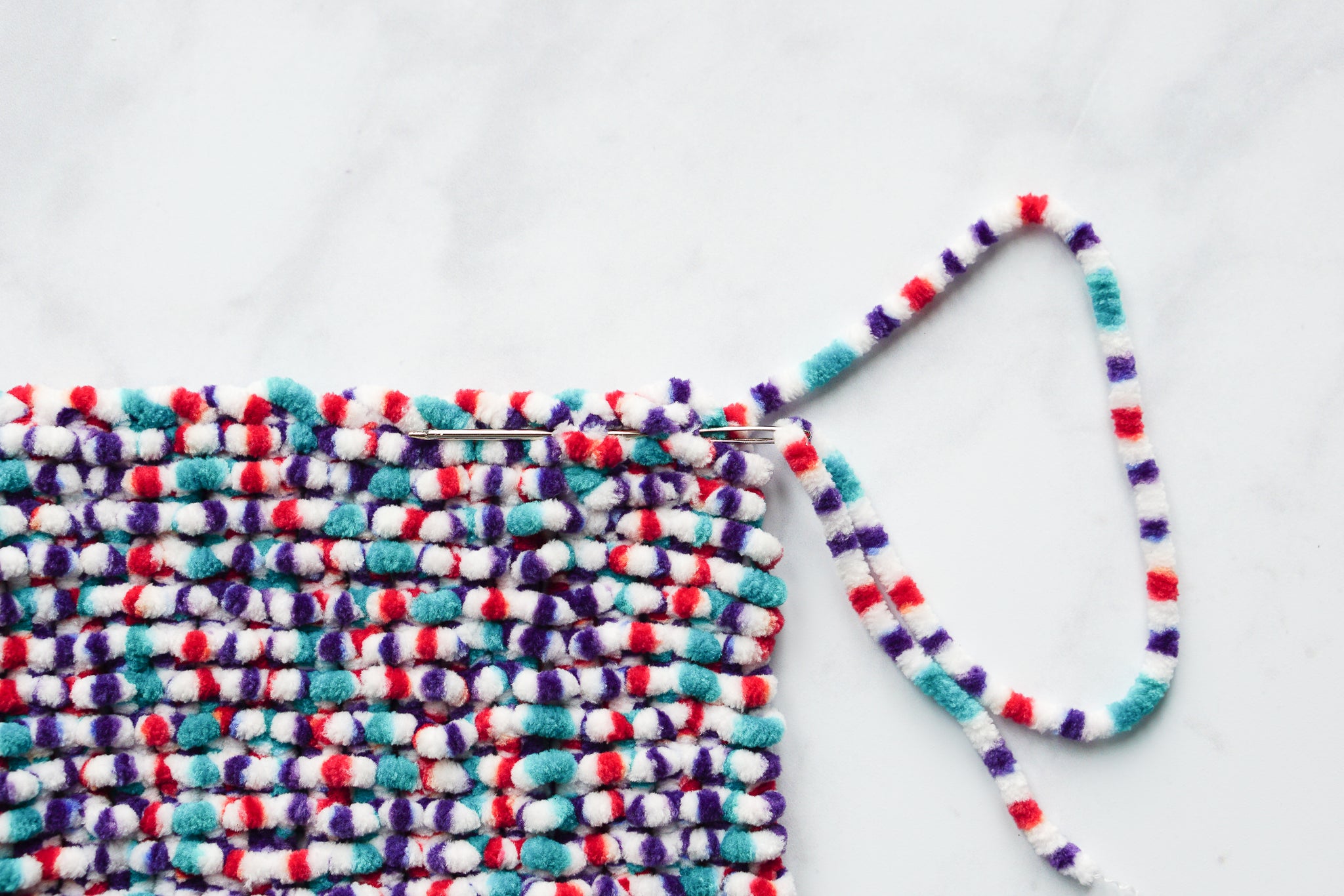 Knit a snuggly blanket for your child's doll's pram