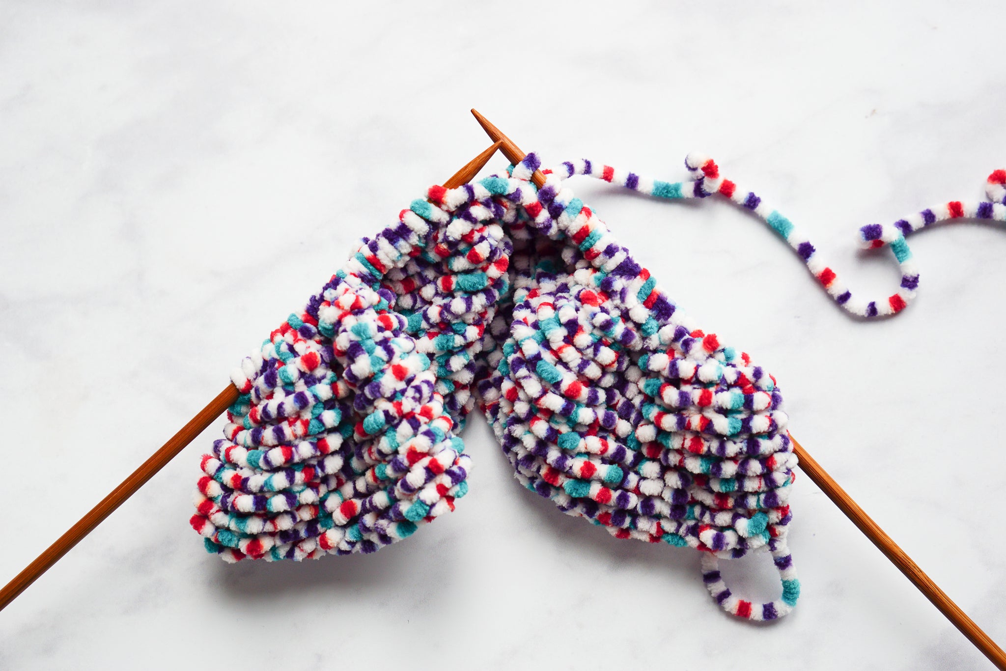 Knit a snuggly blanket for your child's doll's pram