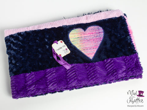 Mad Hatter Warped & Woven Minky Blanket with purple, blue, and pink colours and a handpainted wrap scrap heart.