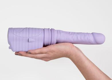 velvet thruster sex toy held in one hand