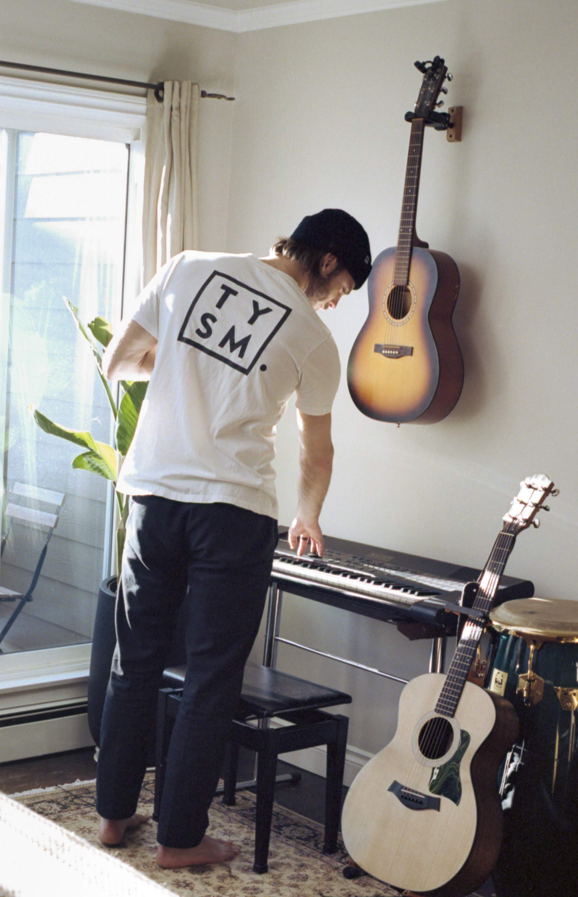 Friend looking at a keyboard in a thankyou T shirt