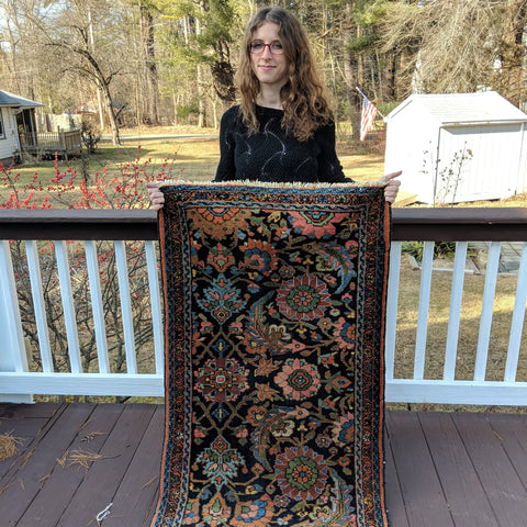 Jess holding Persian rug