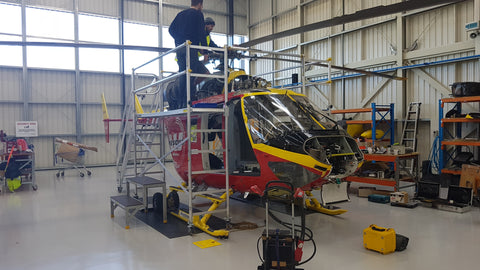 rescue helicopter being worked on with scaffolding