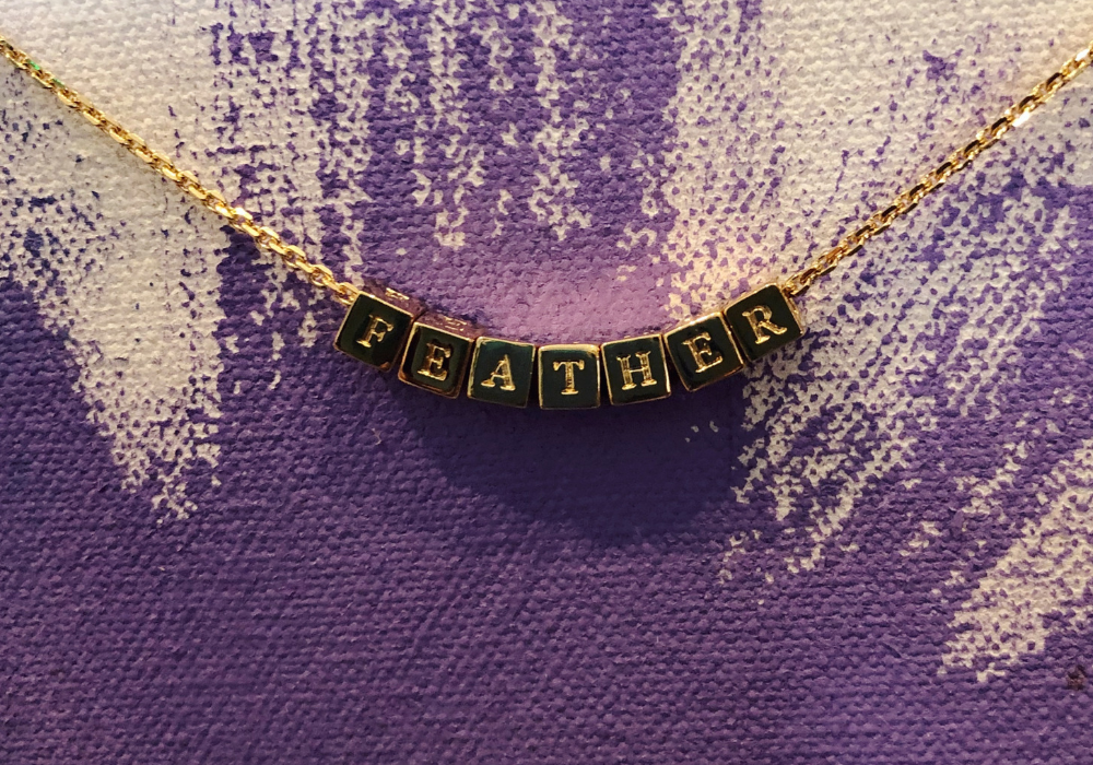 a bracelet that says "Feather"