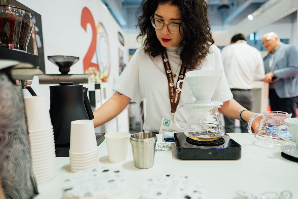 Susie brewing coffee at the Acaia Stand