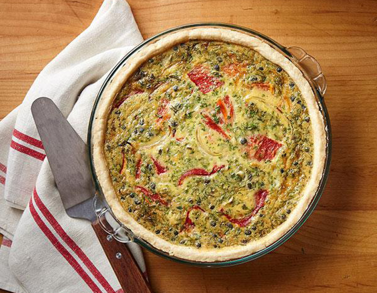 Quiche baking in an old fashioned pyrex glass pie dish