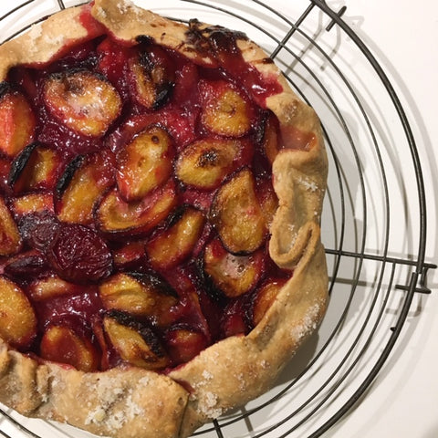 Plum Galette cooling on an antique French rack