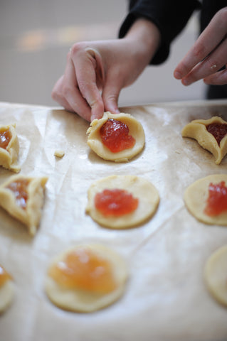Pinching the first corner of the Hamantaschen